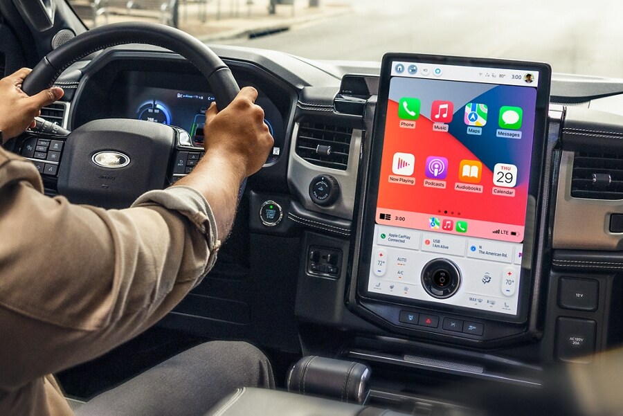 Man driving the 2023 Ford F-150 Lightning® navigating with a 15.5” touchscreen