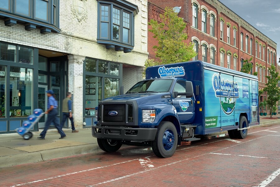 2024 Ford F-750 Regular Cab with beverage truck upfit and custom design on city street