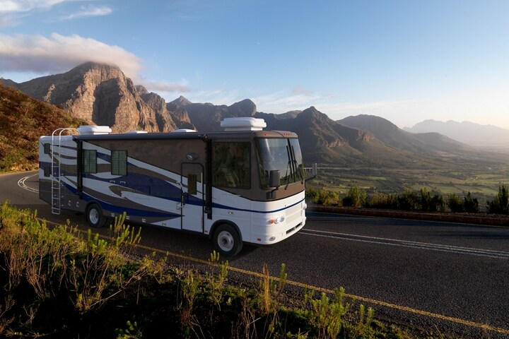 Class A motorhome on a 2023 Ford F-53 Stripped Chassis being driven through the mountains