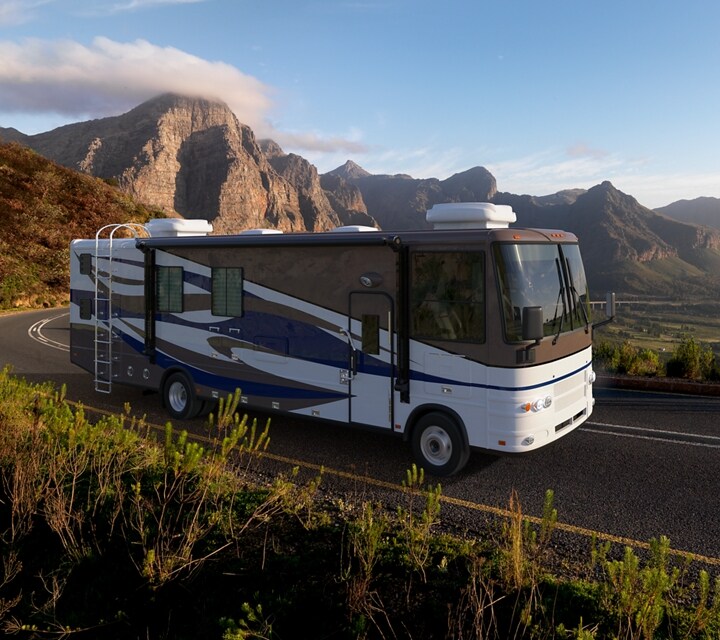 A Motorhome being driven through a mountain range
