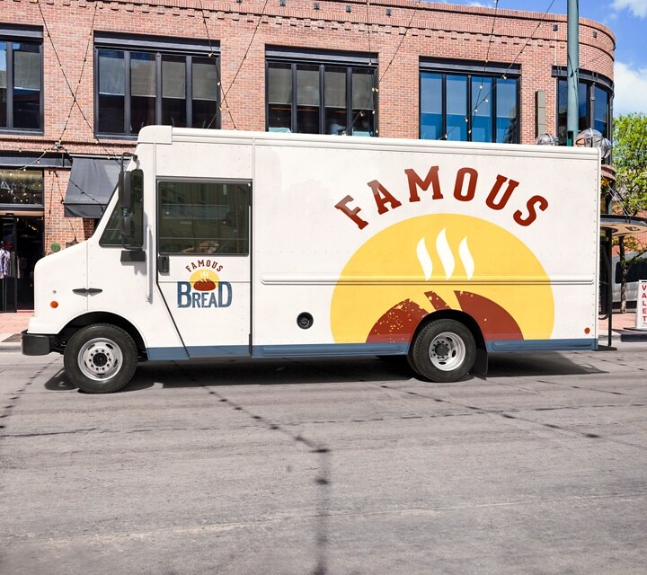 A bakery delivery van parked on a street corner