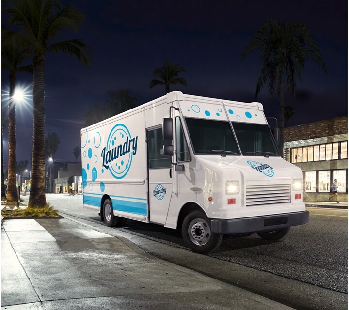 Commercial laundry service vehicle being driven at night