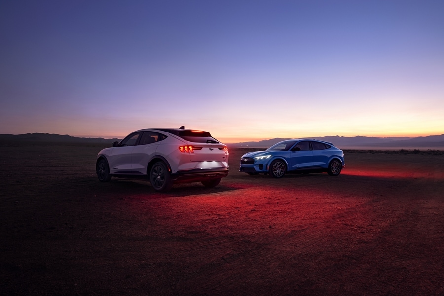 Two 2023 Ford Mustang Mach-E® parked in a desert at dusk