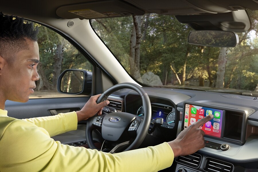 Man parked in 2023 Ford Maverick® truck using standard eight-inch touchscreen