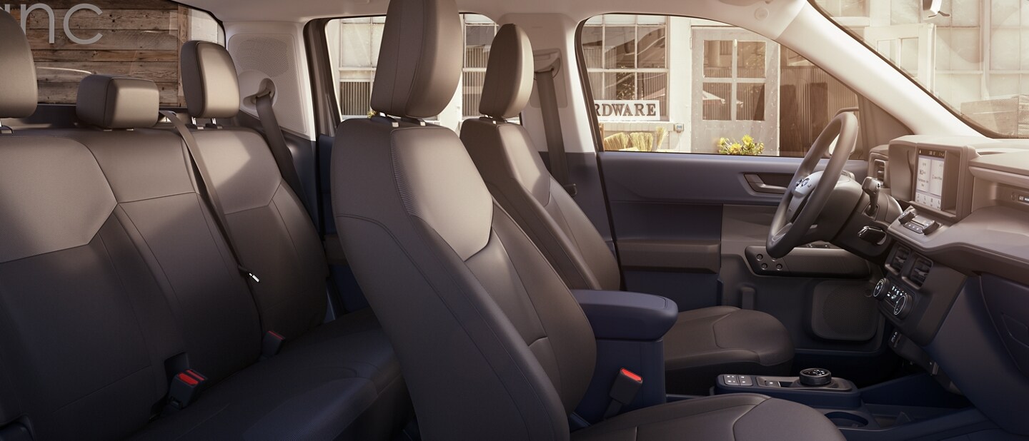 Interior of the 2023 Ford Maverick® XL model with a hardware store visible through the driver’s side window