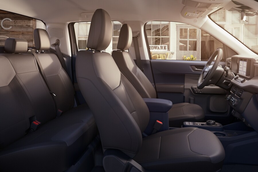 Interior of the 2023 Ford Maverick® XL model with a hardware store visible through the driver’s side window