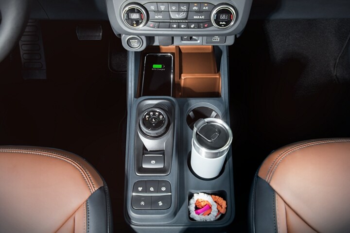 Overhead view of a phone being wirelessly charged in the 2023 Ford Maverick® truck