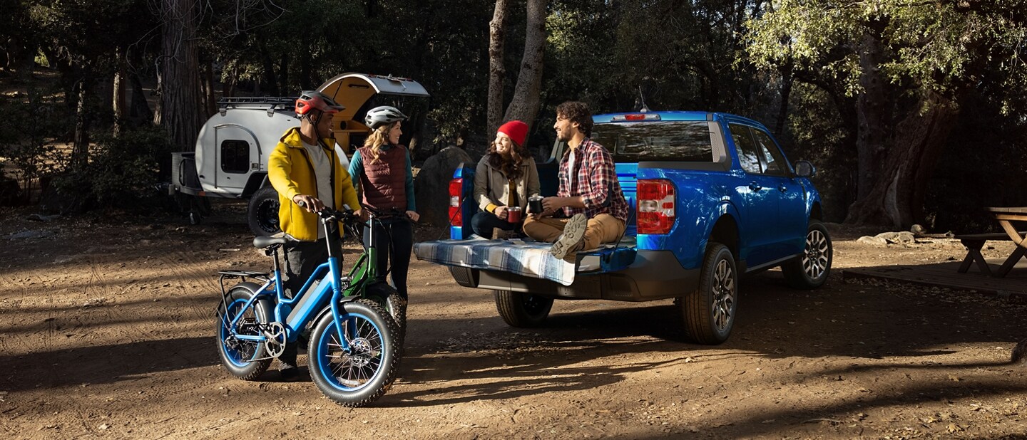 Couple sitting on tailgate of a 2023 Ford Maverick® LARIAT model