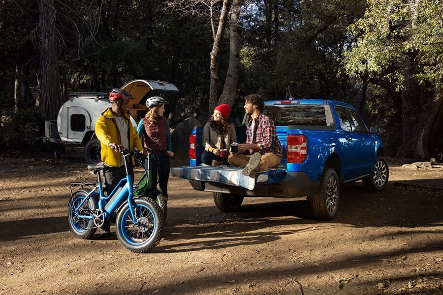 Couple sitting on tailgate of a 2023 Ford Maverick® LARIAT model