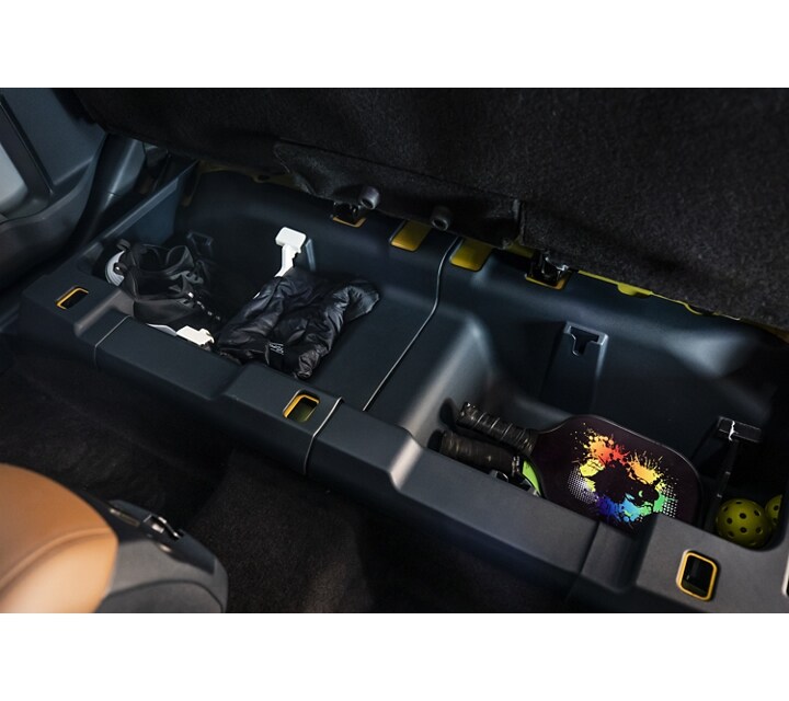 Rear under-seat storage bins inside a 2023 Ford Maverick® truck