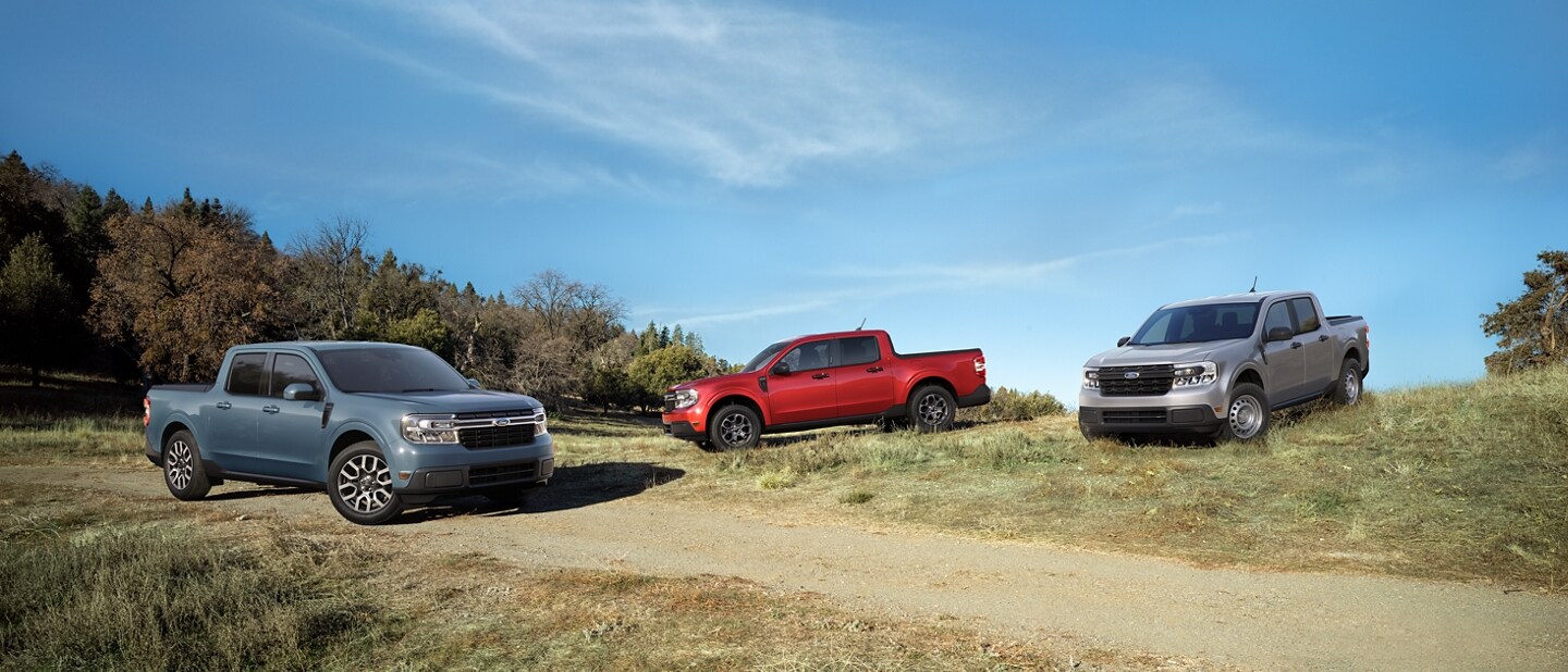 3 parked 2023 Ford Maverick® trucks in the colors Area 51, Hot Pepper Red and Iconic Silver