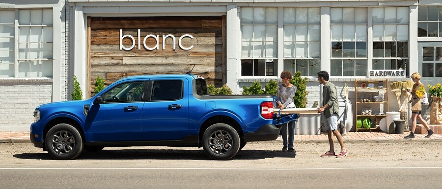 A 2024 Ford Maverick® LARIAT® truck with FX4 Off-Road Package shown in Hot Pepper Red parked in a scenic location
