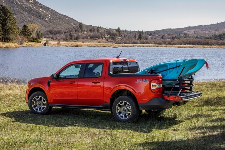 A red 2024 Ford Maverick carrying boats in the bed.