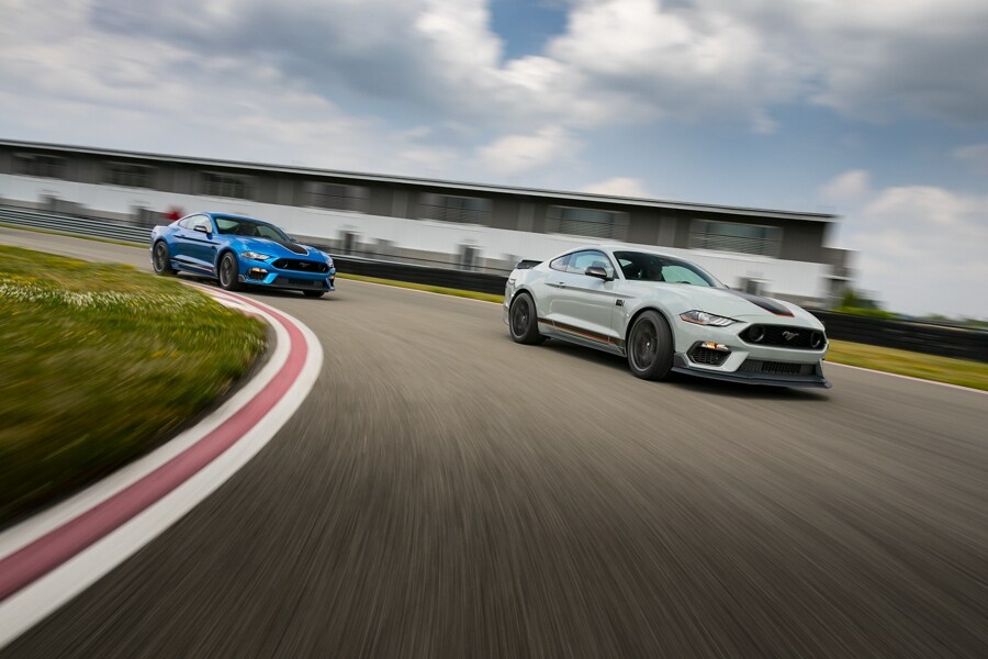 Two 2021 Ford Mustangs being driven on a track