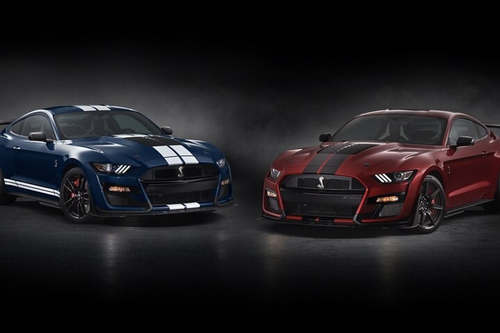 Two 2021 Ford Mustang G T 500s in a dark room
