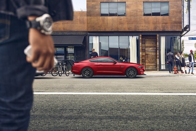 People standing near a parked 2023 Ford Mustang® coupe