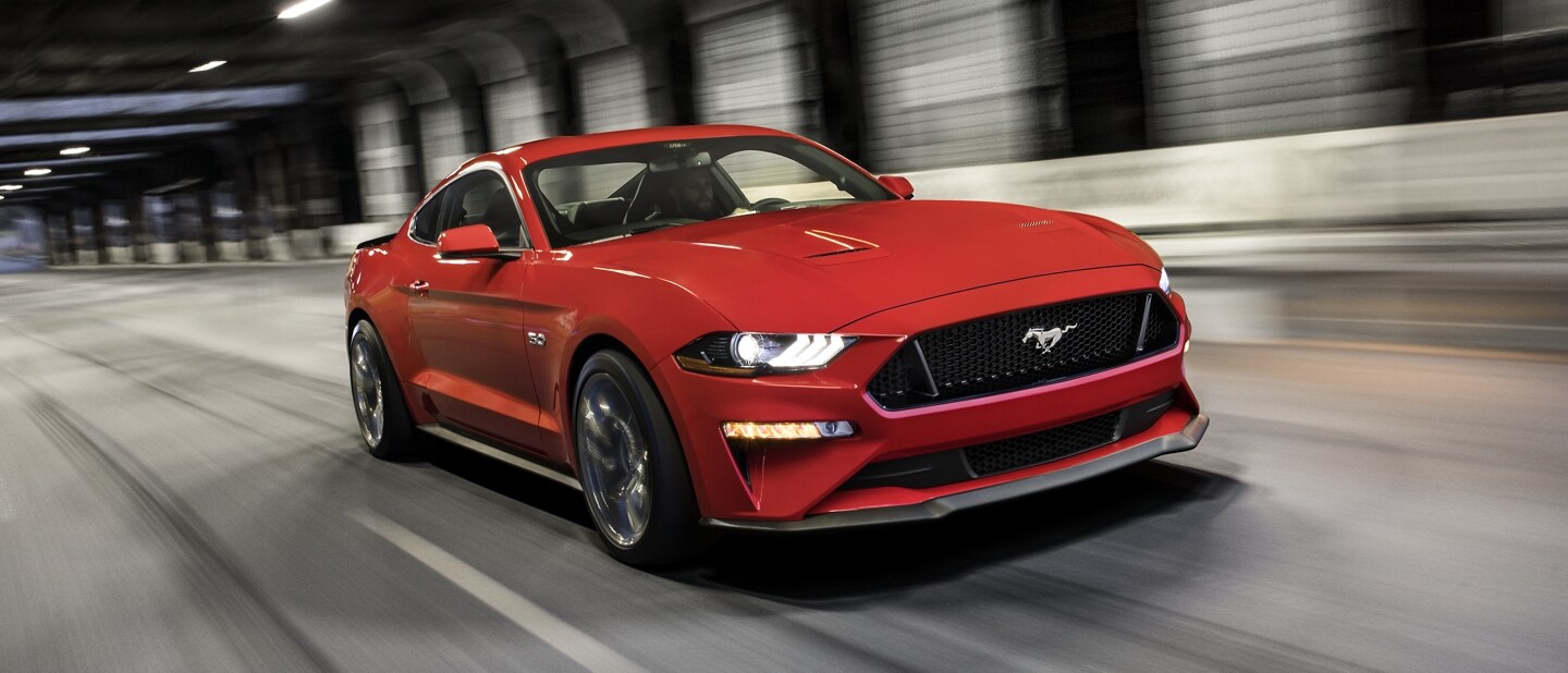 2023 Ford Mustang® GT coupe in Race Red being driven in a tunnel