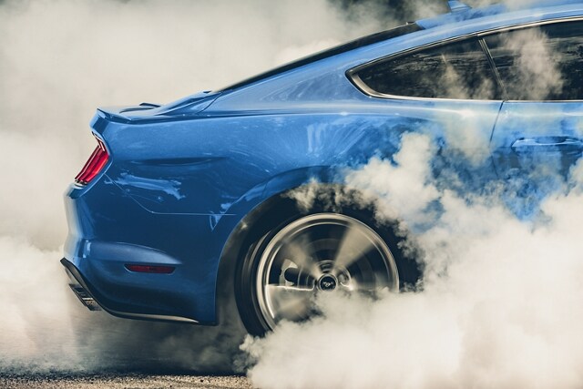 A 2023 Ford Mustang® coupe performing a burnout