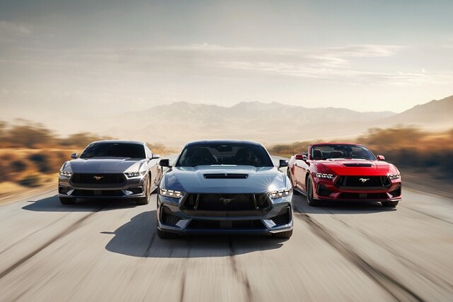 Three 2024 Ford Mustang® vehicles being driven on a desert road