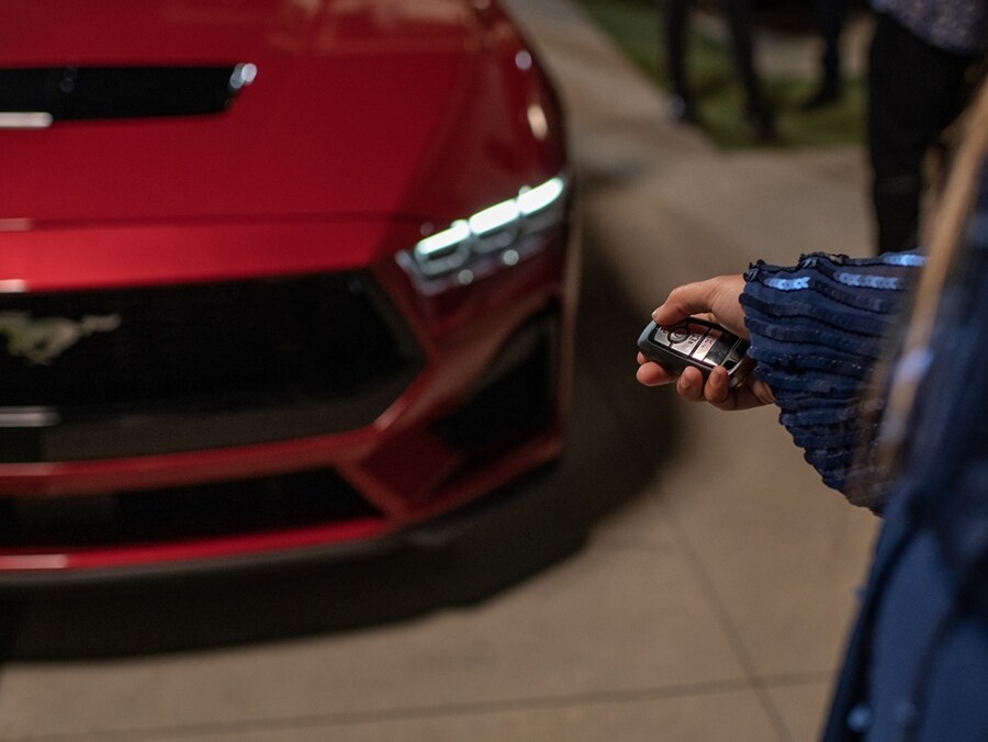 Person using the remote rev feature on a 2024 Ford Mustang® coupe with available automatic transmission
