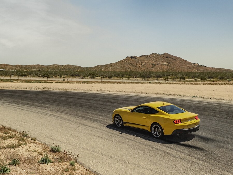 2024 Ford Mustang® EcoBoost® coupe with available Wheel and Stripe package being driven on a desert road