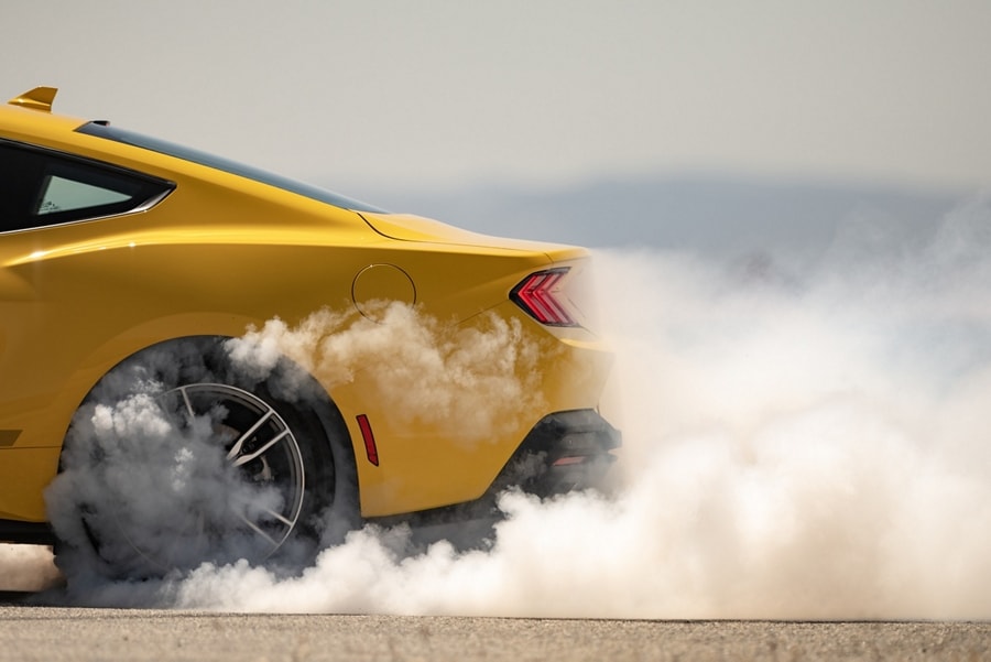 2024 Ford Mustang® EcoBoost® coupe with a driver performing a burnout on a closed course