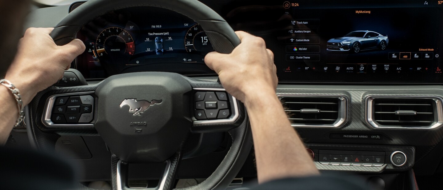 A person driving a 2024 Ford Mustang® coupe