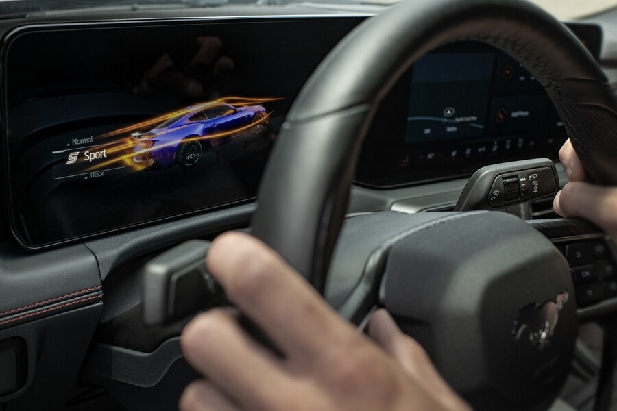 Person driving a 2024 Ford Mustang® model with a view of the cockpit screens