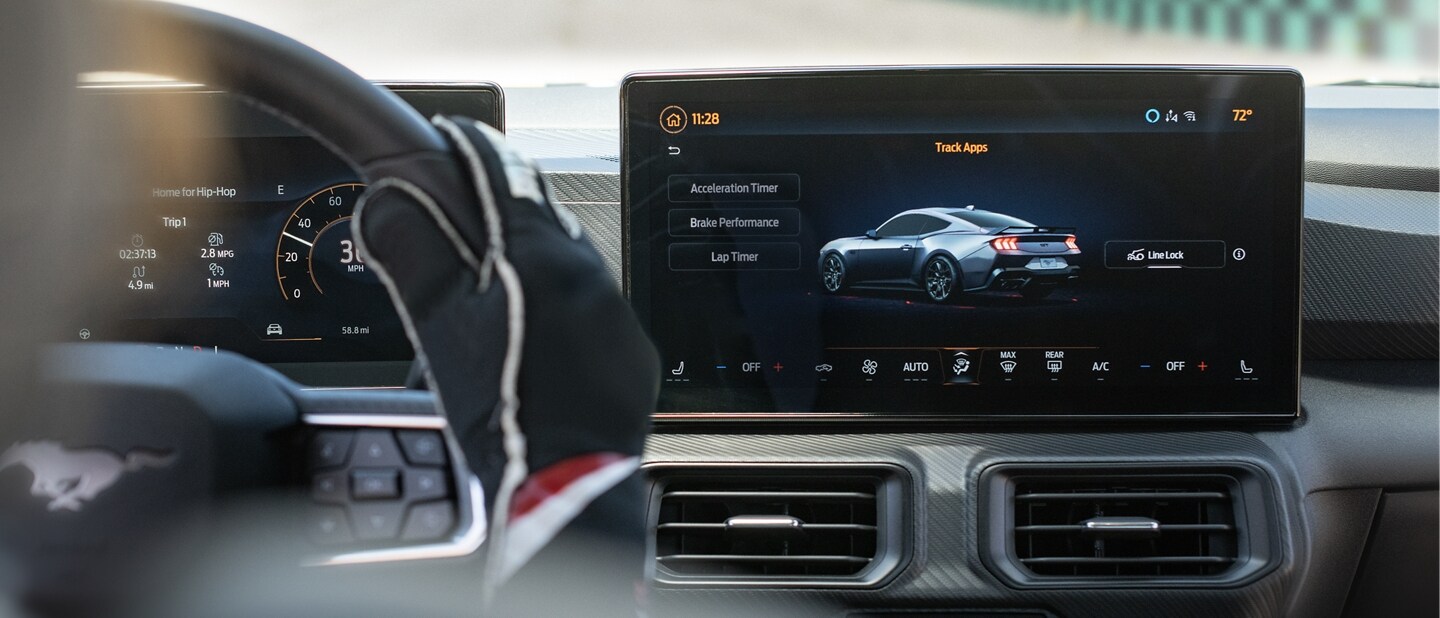 Interior view of a person driving a 2024 Ford Mustang® model on a closed course