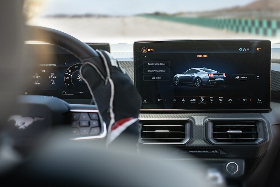 Interior view of a person driving a 2024 Ford Mustang® model on a closed course