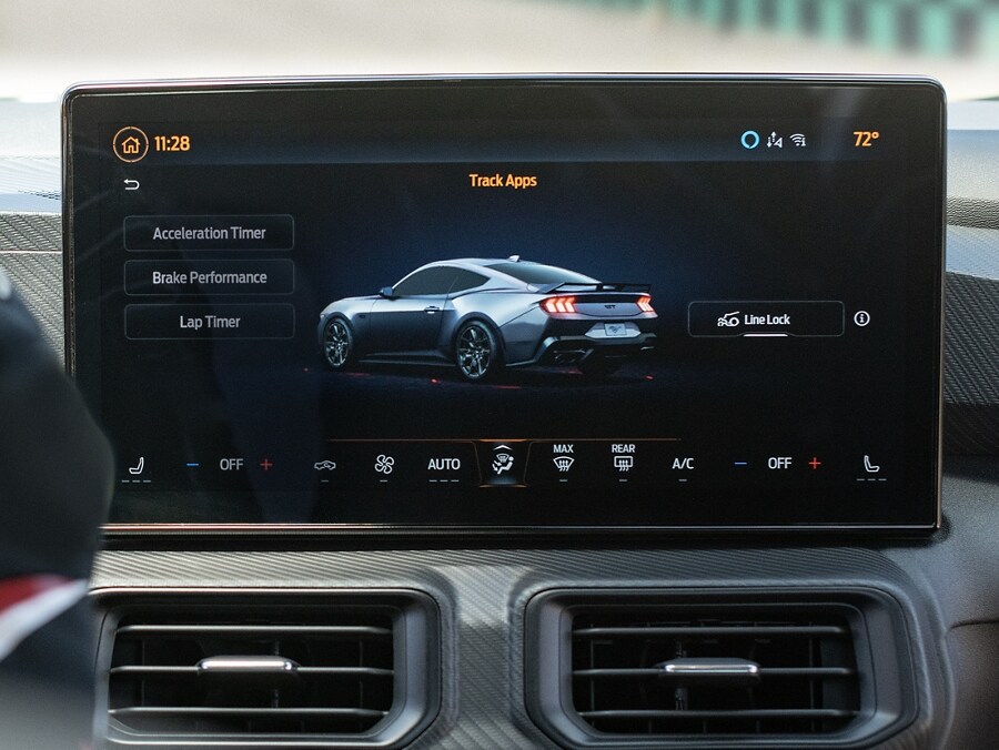 Interior view of a person driving a 2024 Ford Mustang® model on a closed course