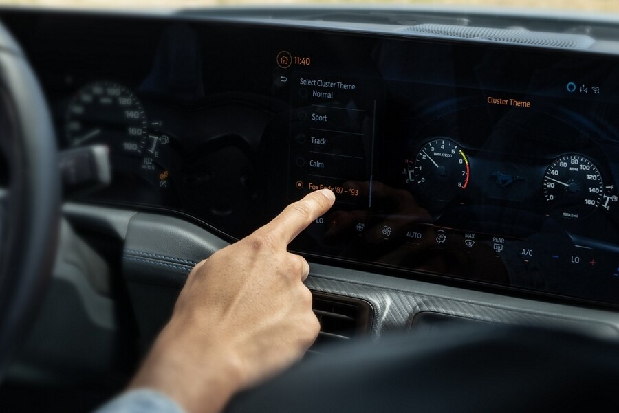 Person using the touchscreen in a 2024 Ford Mustang® model