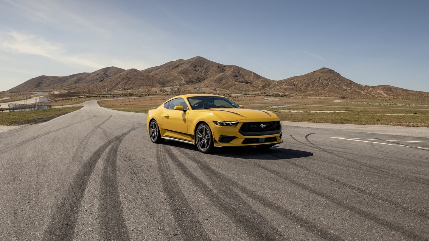 2024 Ford Mustang® EcoBoost® coupe with available Wheel and Stripe package on a racecourse