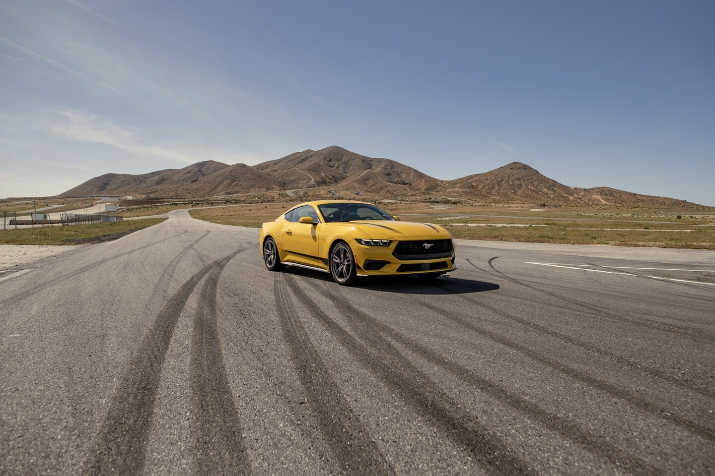 2024 Ford Mustang® EcoBoost® coupe with available Wheel and Stripe package on a racecourse