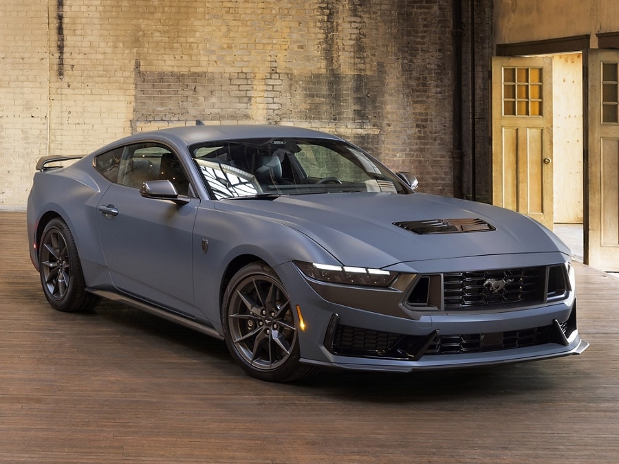 2024 Ford Mustang® GT coupe with Mustang Nite Pony Package and available Matte Clear Film parked in an industrial building