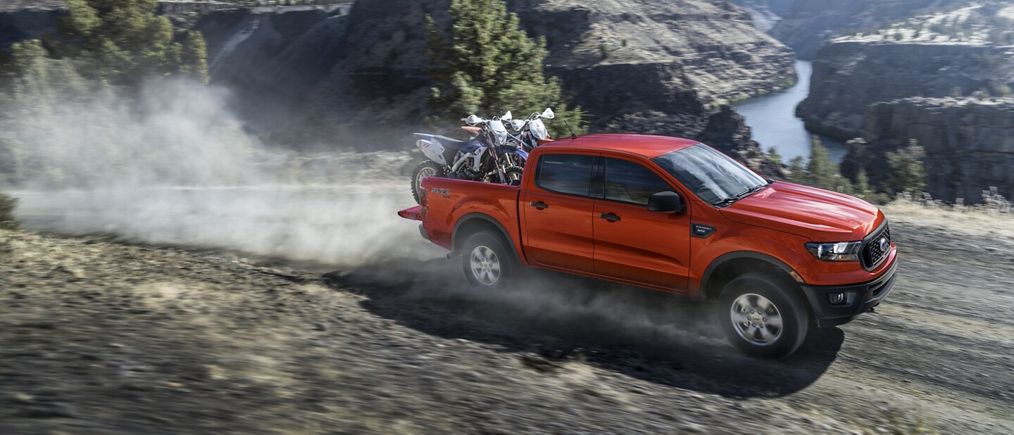2021 Ford Ranger in Race Red hauling a pair of motor bikes