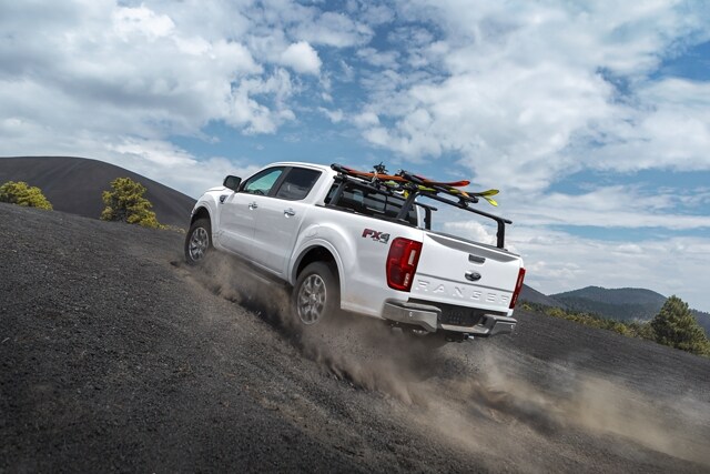 2021 Ford Ranger LARIAT F X 4 shown in Oxford White kicking up dust