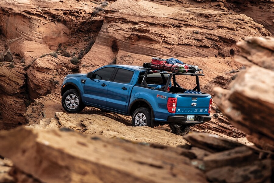 2023 Ford Ranger parked on rocks with gear on bed-mounted rack