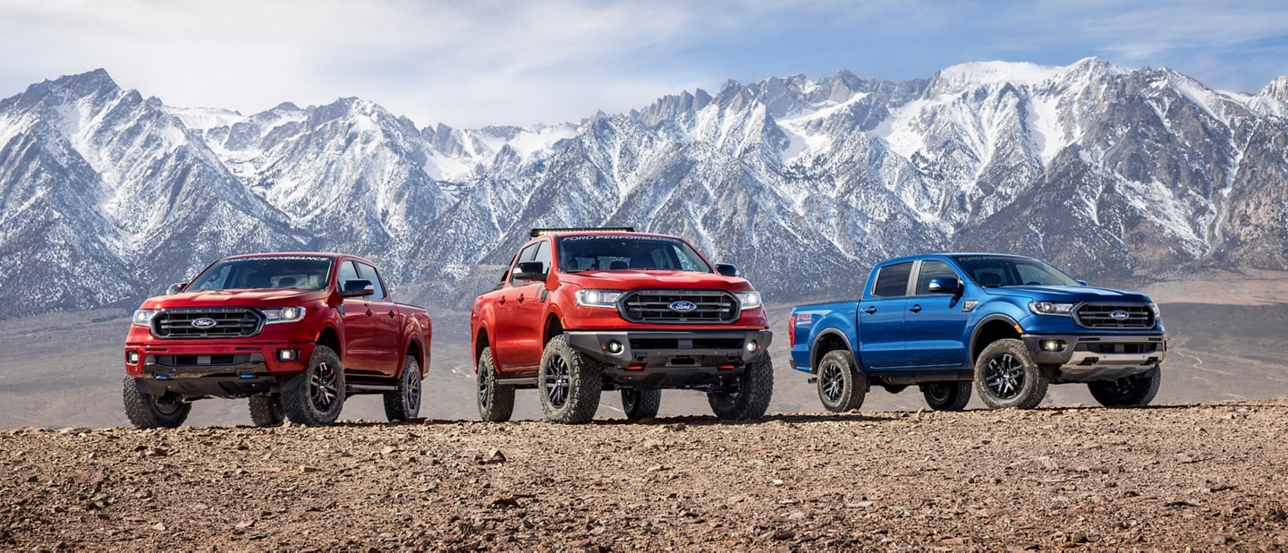 Three 2023 Ford Ranger trucks parked in front of a snowy mountain