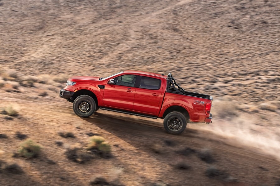 Se muestra una Ford Ranger® FX4 2023 en Hot Pepper Red Metallic levantando polvo en el desierto