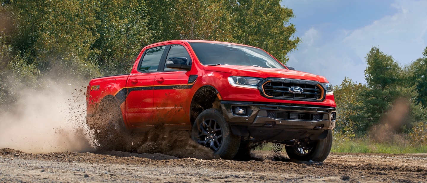 2023 Ford Ranger® Splash Edition in Race Red kicking up dirt on a trail