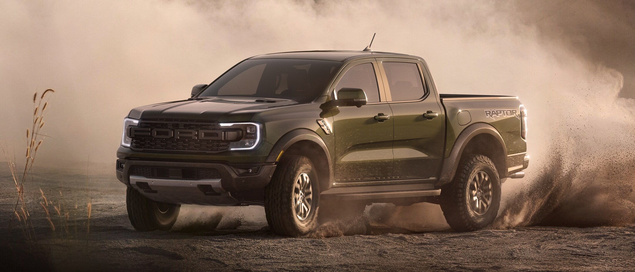 2024 Green exterior ford raptor drifting through sanding terrrain