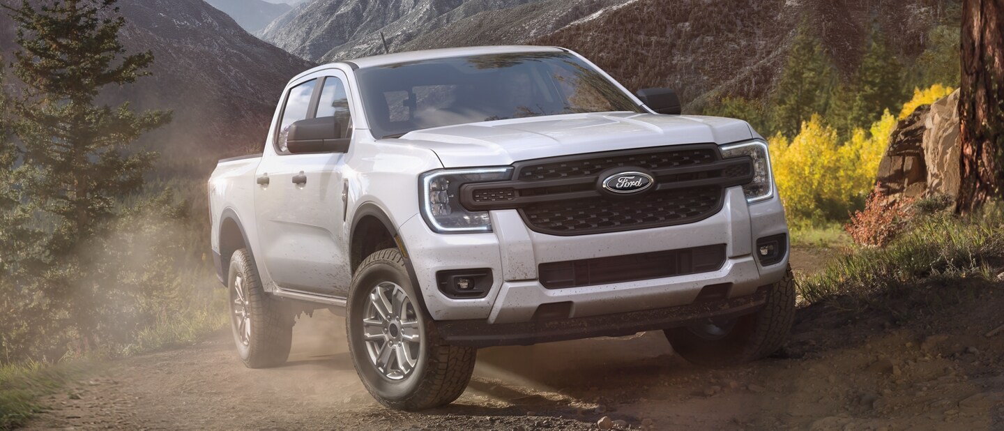 A 2024 Ford Ranger® in Oxford White on a dirt road in a scenic setting