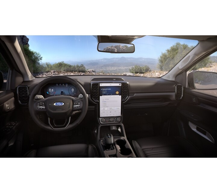 A close-up of the dash and center touchscreen with an outside view in a 2024 Ford Ranger®