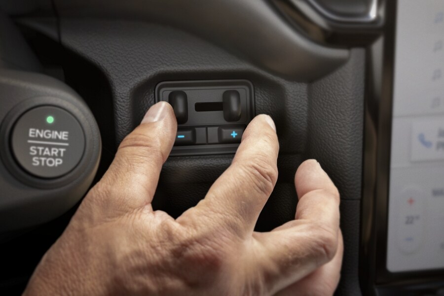 Close-up of a hand touching a dial on a 2024 Ford Ranger®