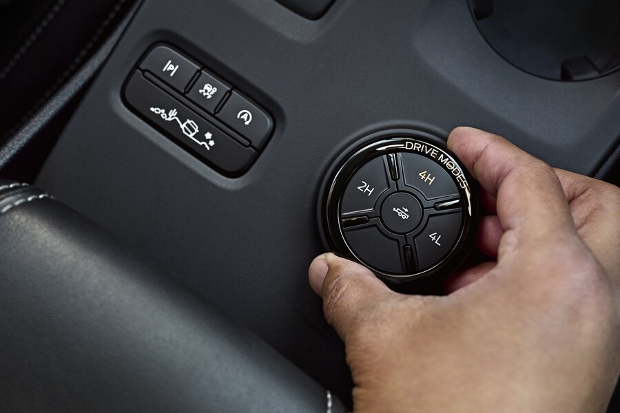 A person's hand is rotating a knob inside a 2024 Ford Ranger®