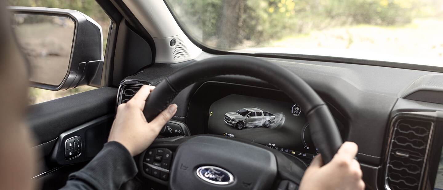 Close-up of a 2024 Ford Ranger® truck steering wheel and dash with two hands in view