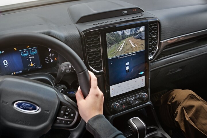 The interior of a 2024 Ford Ranger® XLT with two people engaged with the dash