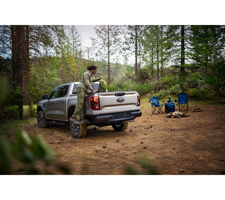 A 2024 Ford Ranger® parked in a scenic location with people loading bikes in the truck bed