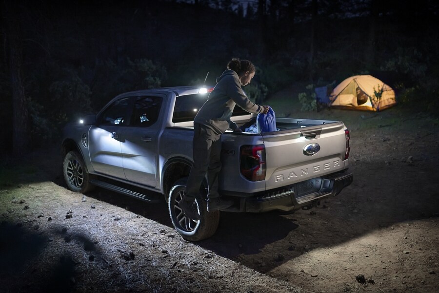 A 2024 Ford Ranger® is parked at a campsite at night with the truck lit up by Zone Lighting